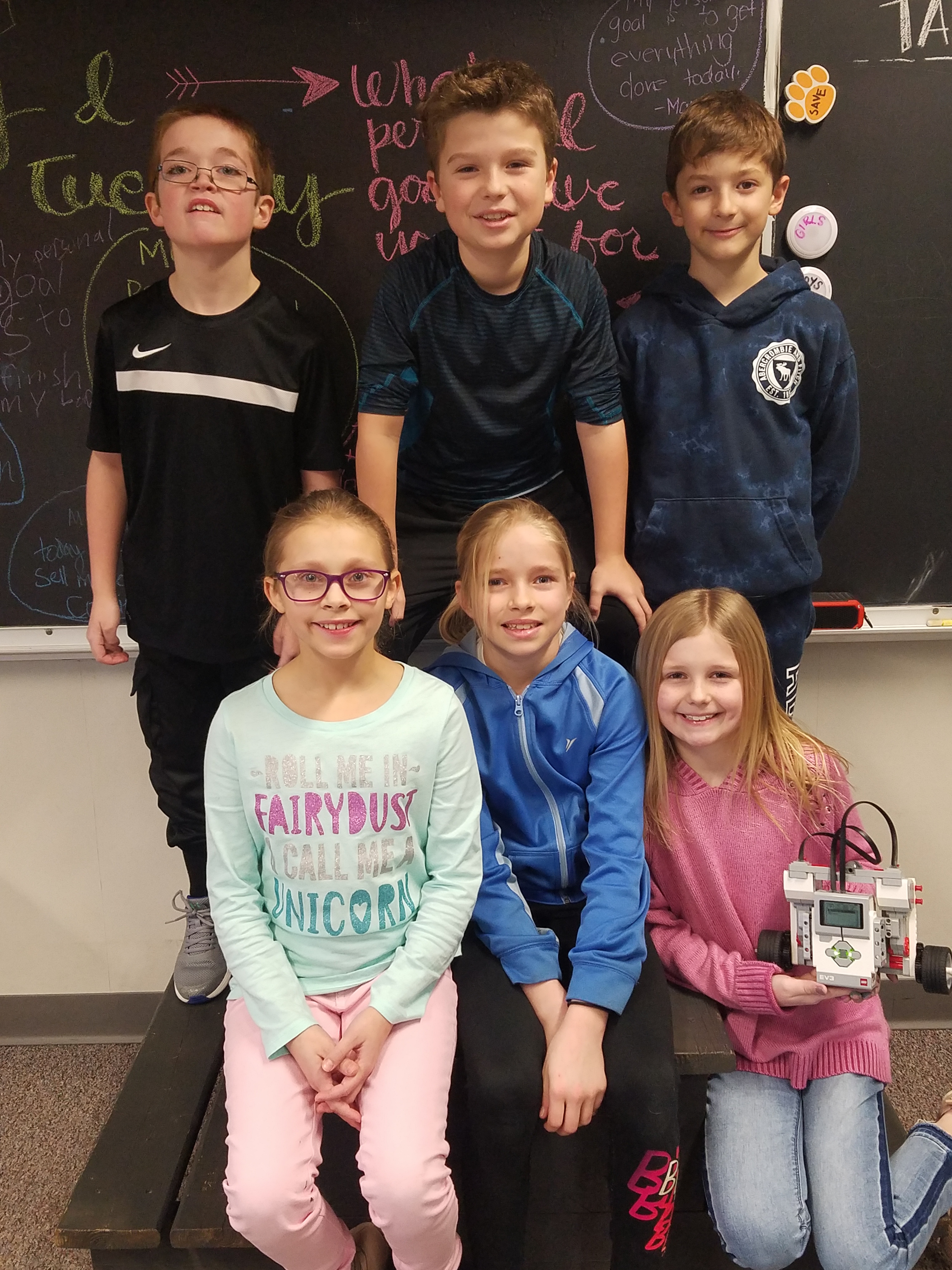 4th Grade students show off their robotics project.