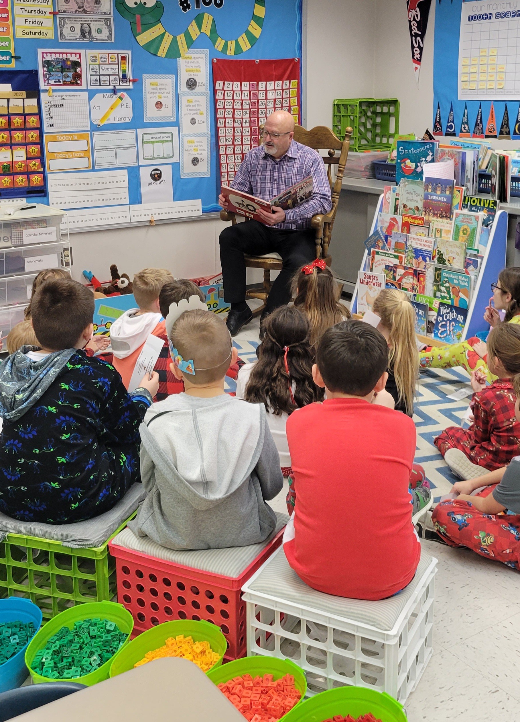 Superintendent, Dr. Veracco, reads to Kolling students during the Holiday Reading Extravaganza.